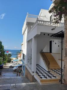 萨兰达Bistrica Hotel的白色的建筑,设有楼梯,享有海景