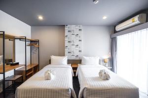 U- Homehotel Nakhonpanom客房内的一张或多张床位