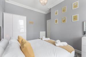 邓弗姆林No 46 - by StayDunfermline的一间白色卧室,配有两张床和吊灯