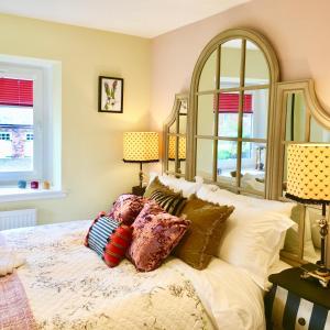 林利斯戈The Little Beech Tree的一间卧室配有带枕头的床和2个窗户。