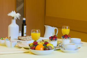 O Pindo阿里亚斯酒店的一张桌子,早餐包括水果和果汁