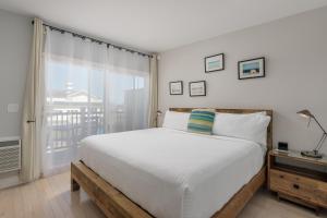 蒙托克蒙托克阿奎丽娜汽车旅馆的一间卧室设有一张大床和一个窗户。
