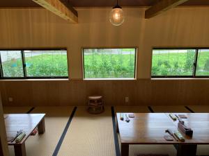 Kokuryō無鹿リゾート的一间设有两张桌子和三扇窗户的房间