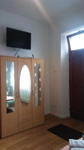 柏林Ferienwohnung 3的客房设有电视和带镜子的橱柜。