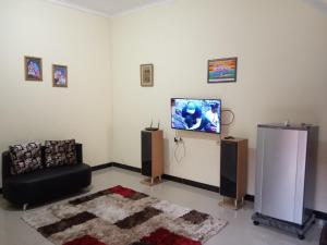 直葛Homestay Tegal Kota by Simply Homy的客厅配有平面电视和沙发。