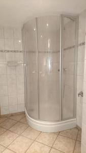 库罗阿尔滕堡Gästehaus Meierbaude的浴室铺有白色瓷砖,设有淋浴间。