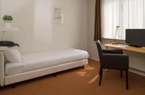 埃德德博瑟朗公园酒店的客房设有一张床、一张桌子和一台电脑