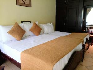 基图尔格勒Kithulgala Rest House的一张配有白色床单和枕头的大床