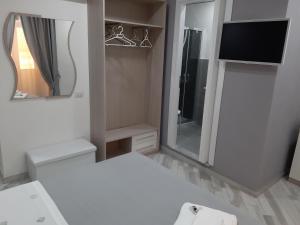 克罗托内Il Diamante的一间带电视和镜子的浴室