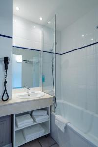 比亚里茨比亚里茨海洋酒店的浴室配有水槽、淋浴和浴缸。