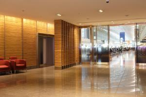 东京Haneda Excel Hotel Tokyu Haneda Airport Terminal 2的大厅,大楼,有红色椅子和走廊