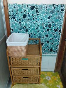 Towa昭和の宿 汐凪 shionagi的浴室设有篮子和蓝白色的墙壁