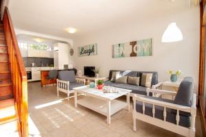 莫甘Flatguest PR Beach - Terrace + Garden + 24H的客厅配有沙发和桌子