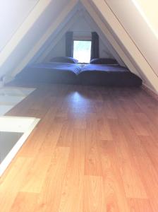 OxfordOxford Tiny House的阁楼上设有1间带1张床的卧室,铺有木地板