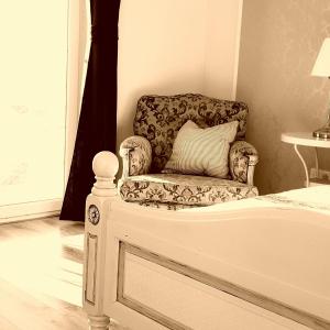 茨里克韦尼察Apartments Villa Harmonie - Adults Only +14的坐在房间床边的椅子