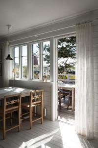 莫勒松德Kvarnstugan的一间带桌子和一些窗户的用餐室