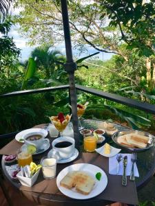 多米尼克Casa del Toucan的餐桌,早餐包括烤面包、咖啡和果汁
