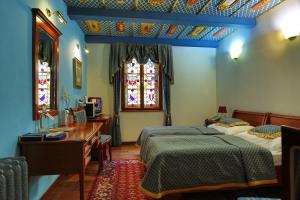 布尔诺里克皇家酒店的一间卧室设有两张床、一张桌子和一个窗口。