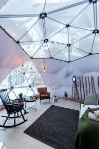 阿尔塔GLØD Aurora Canvas Dome的一个带沙发和椅子的帐篷的房间