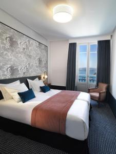 芒通圣贝尔纳门冬帕拉斯酒店的一间设有大床和窗户的酒店客房