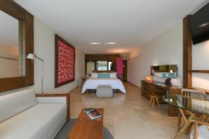 普拉亚卡门Hotel Xcaret Mexico All Parks All Fun Inclusive的酒店客房,配有床和沙发