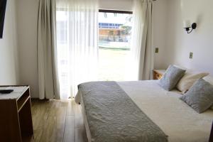 拉塞雷纳卡巴纳斯维嘉苏度假屋的一间卧室设有一张床和一个大窗户