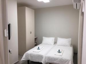 耶路撒冷西格尔耶路撒冷公寓的卧室配有白色床和2个白色枕头
