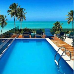 若昂佩索阿Hotel do Mar Cabo Branco的享有海滩景致的游泳池