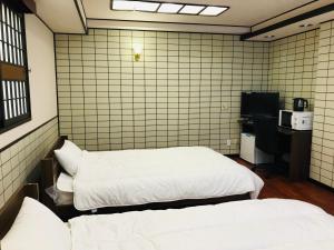 Guesthouse & Hotel RA Kagoshima客房内的一张或多张床位