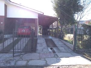 圣罗莎卡拉穆奇塔县Departamento Loma Hermosa的车库,有车停在围栏下