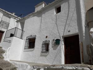 卡皮雷拉Casa Rocio的白色的建筑,有三扇窗户和门