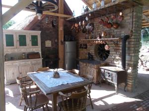巴拉顿诺尔马迪200 éves vendégház的厨房配有桌子和石墙