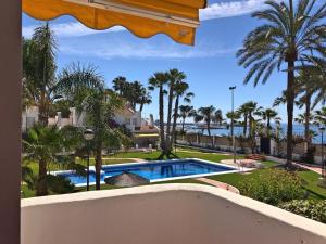 卡莱塔德贝莱斯Beachfront oasis in Costa del Sol.的设有一个游泳池的度假村阳台,享有风景