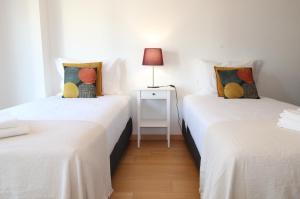 里斯本Parque das Nacoes River view ,free wifi的配有两张单人床的房间,配有台灯