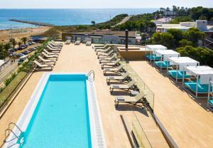 萨洛Golden Costa Salou - Adults Only 4* Sup的一个带躺椅的游泳池和海滩