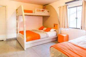 伊瓜苏康塞特精品套房旅馆的一间卧室设有两张双层床和一扇窗户。