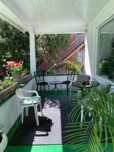 埃德蒙顿Quaint & Cozy Accommodation的一个带桌椅和植物的屏蔽门廊