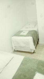 圣保罗Hotel Novo Oriente Brás的白色卧室配有一张带白色桌子的床