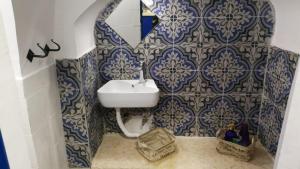 萨法德בבית של סבתא וסבא的浴室设有水槽和蓝色及白色瓷砖