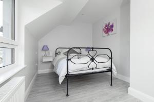 纽里Godfrey Mews的白色卧室,配有带金属框架的床