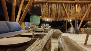 海神庙Coco Verde Bali Resort的餐厅设有一张桌子,上面放着酒杯