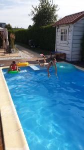 帕克Dom przy Basenie的两个女孩在游泳池里玩炸薯条