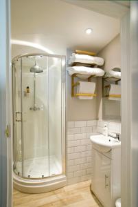 托特尼斯Hunters Lodge Inn的带淋浴和盥洗盆的浴室