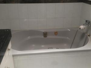 罗萨里奥港Mi casa的白色瓷砖浴室内的白色浴缸