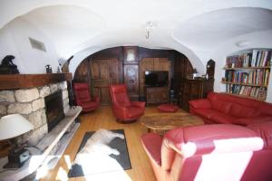 Villar-dʼArèneChez Jean Pierre - Room 1pers in a 17th century house - n 6的客厅设有红色的沙发和壁炉