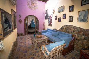 达哈布波西米亚公寓的客厅设有蓝色的沙发和石墙
