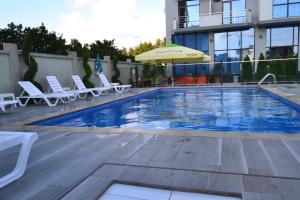 巴统Hotel Skyline Batumi的一个带躺椅和遮阳伞的游泳池
