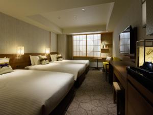 Mitsui Garden Hotel Kyoto Station客房内的一张或多张床位