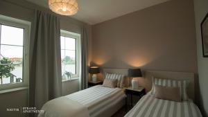 NAUTIK STRANDAPARTMENTS Luxuswohnung Atlantik客房内的一张或多张床位