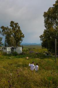 NaturNATURA-eco farm的两个人坐在草地上